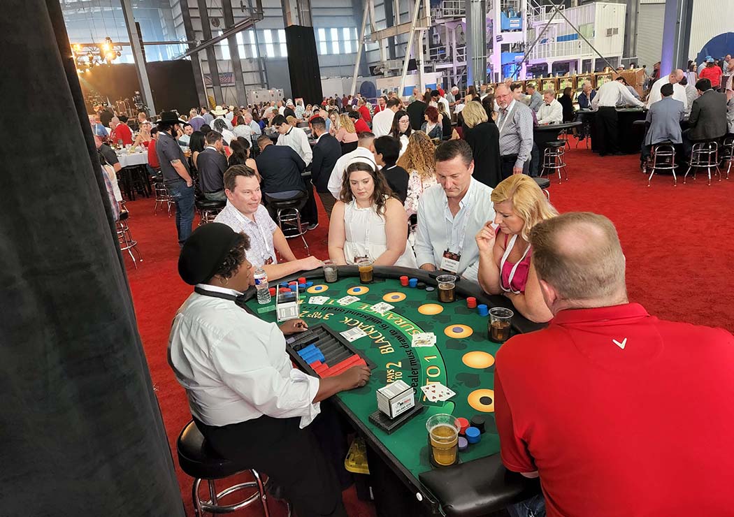 People playing blackjack at a casino night party in Conroe.