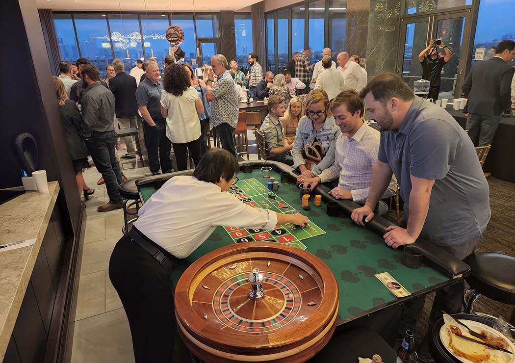 People playing roulette at an apartment complex resident appreciation casino night party in Houston.