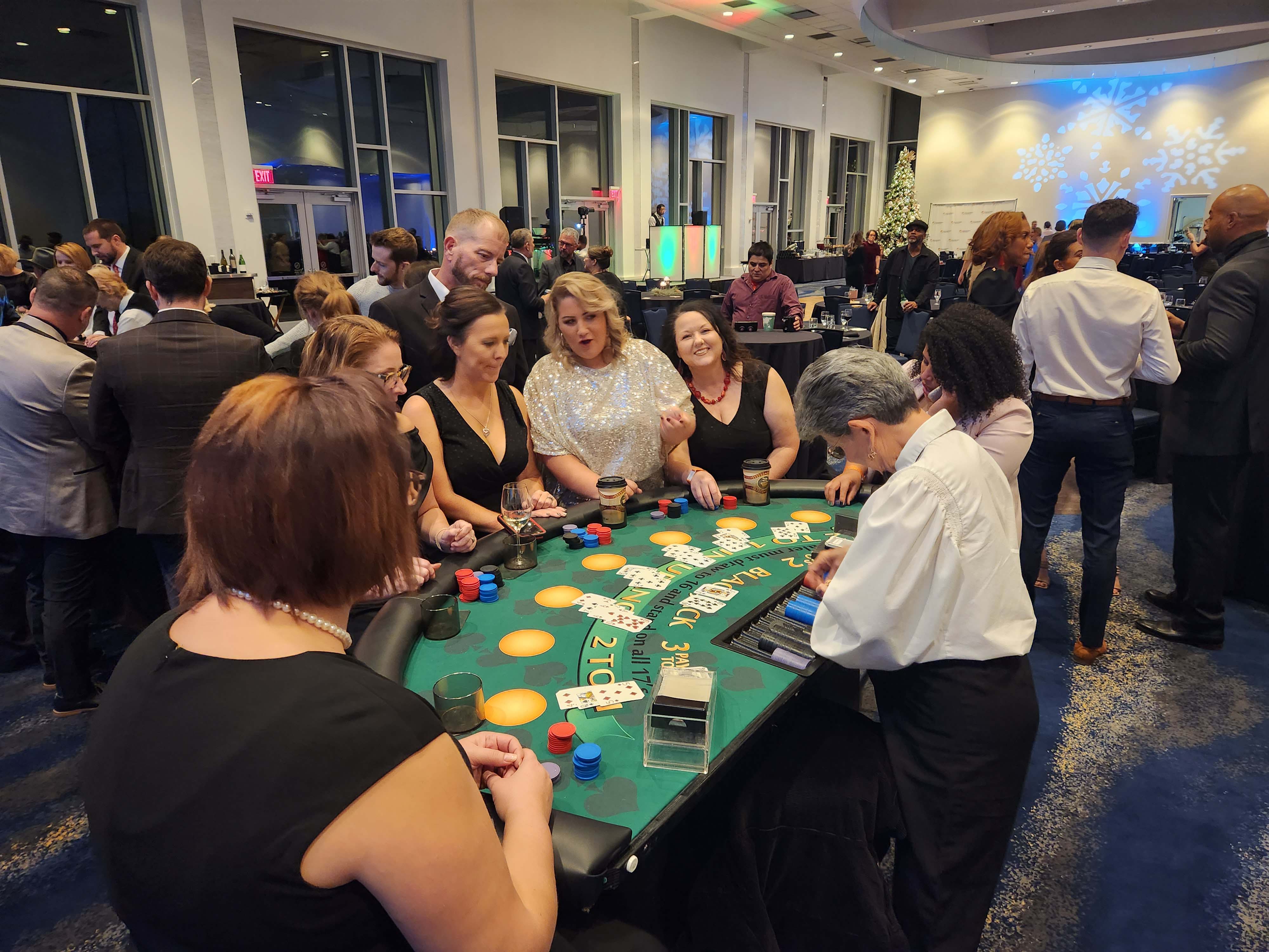 Blackjack table with players and dealers at a Holiday Party