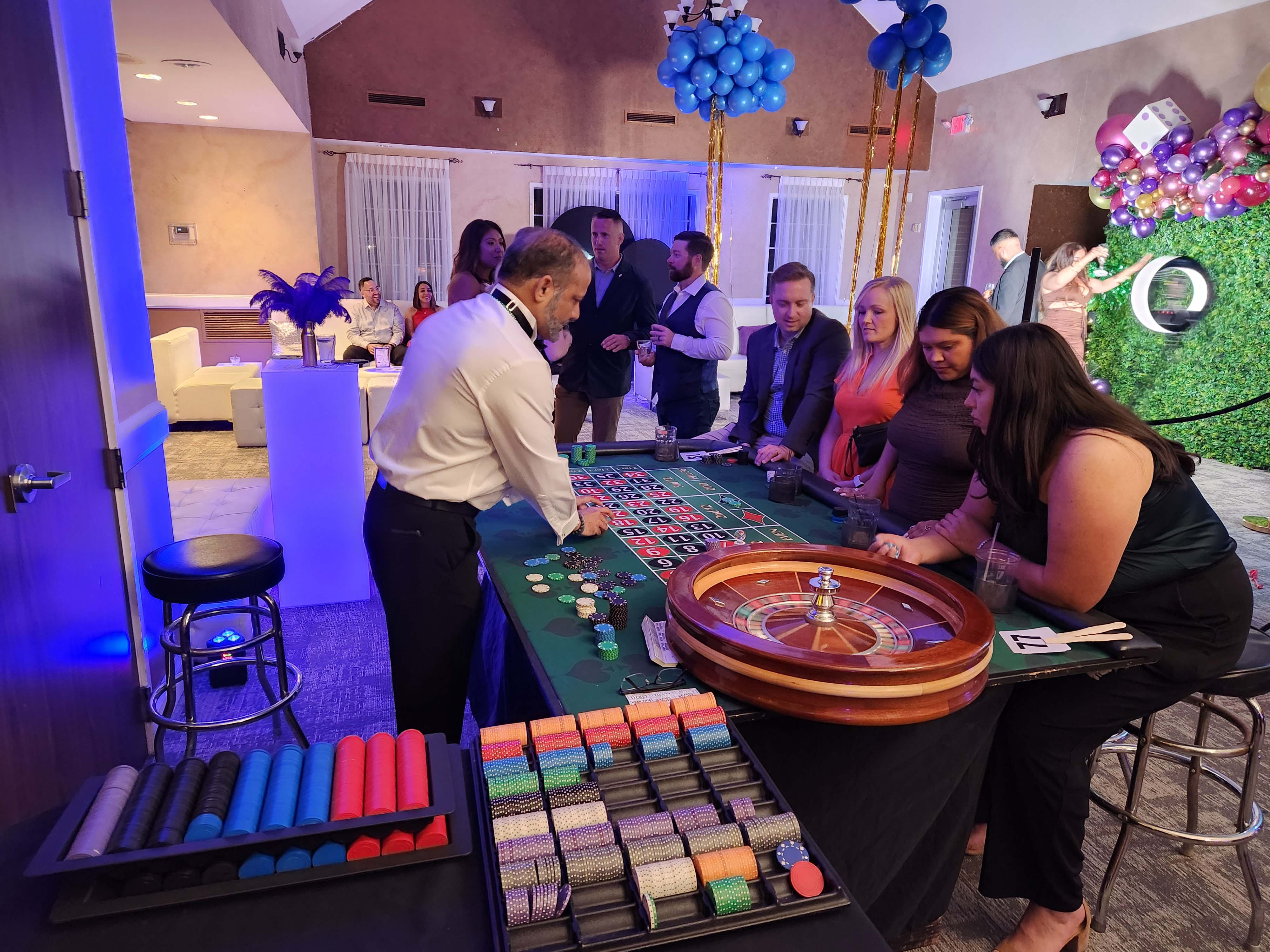 People playing roulette at a casino night party in Katy.