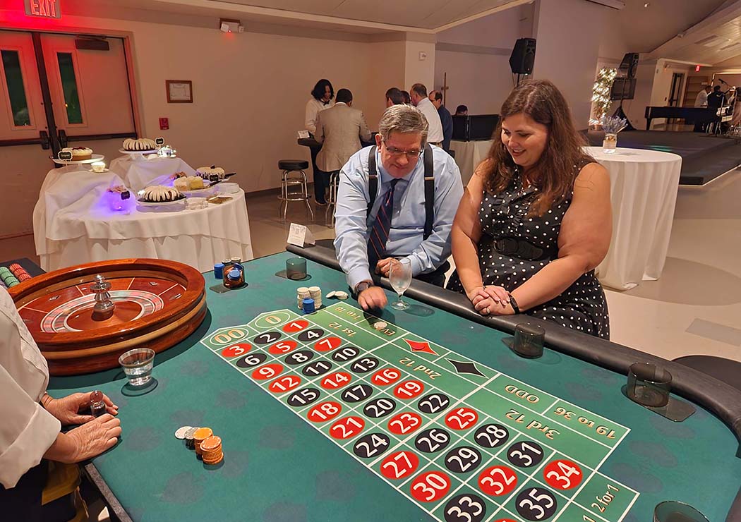 People playing roulette at a Kentucky Derby party in Sugar Land.