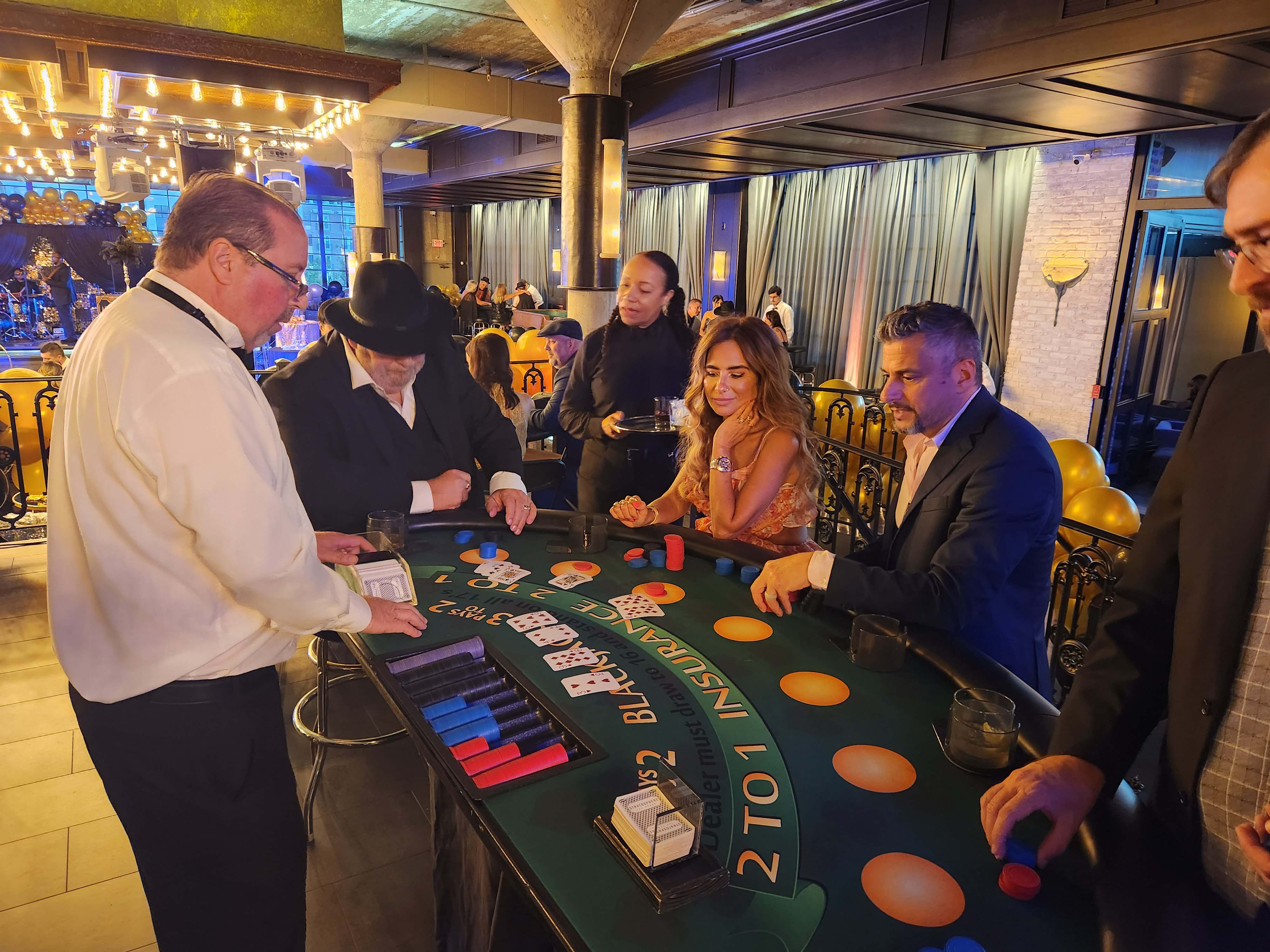 People playing blackjack at a fundraising gala in Houston.